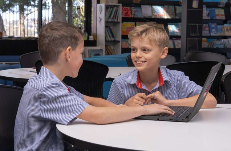 2 students with laptop