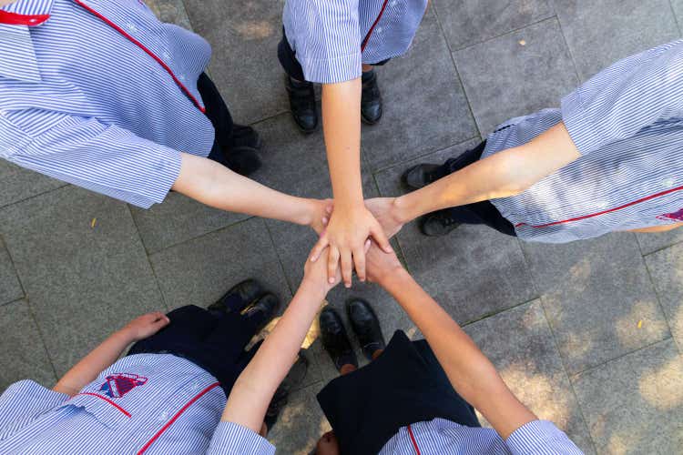 students with hands together